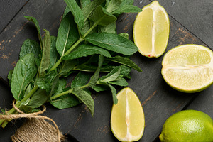 Bunch of fresh green mint on wooden board and lime wedges, top v, a Nature Photo by ndanko