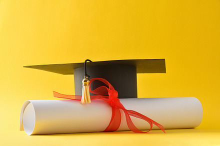 Academic cap and diploma with red ribbon isolated on yellow