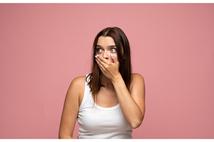 Young woman covering mouth in shock, a Person Photo by volodymyrshtun13795