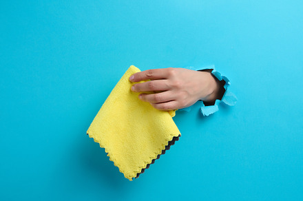 female hand sticking out of a torn hole in a blue paper backgrou, a Person Photo by ndanko