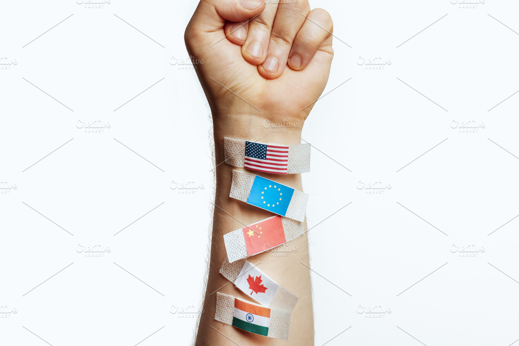 Fragile Global Ties - Flags Tearing on Arm, a Business Photo by Alliance Images