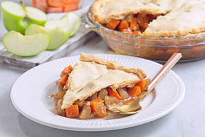 Homemade apple and sweet potato cobbler pie on white plate, horizontal, a Food & Drink Photo by iuliia_n