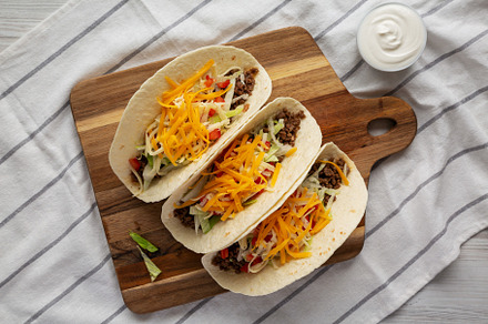 Homemade American Beef Tacos with lettuce, tomato and cheese on, a Food & Drink Photo by LiudmylaChuhunova