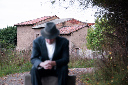 emigrant with suitcase and vintage suit leaving his village to l