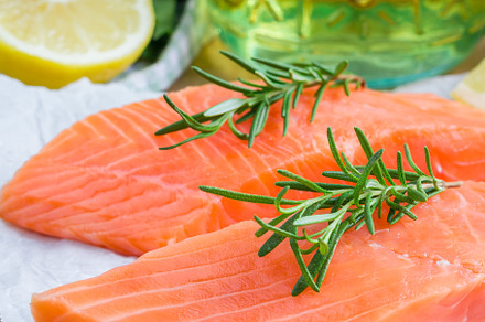Fresh raw salmon fillet with rosemary and lemon, a Food & Drink Photo by iuliia_n
