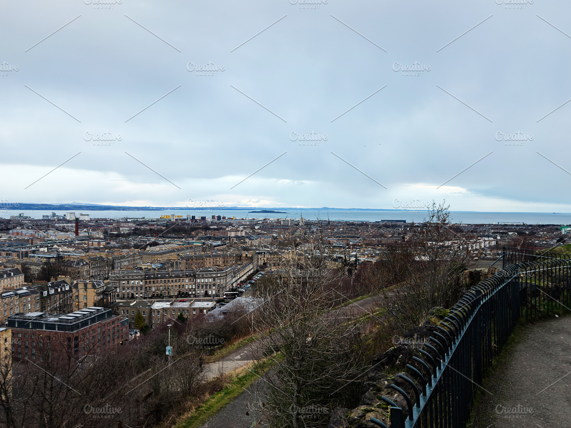Panoramic city view of Edinburgh, Scotland, UK from a hilltop promenade overloo, a Photo by AS photostudio
