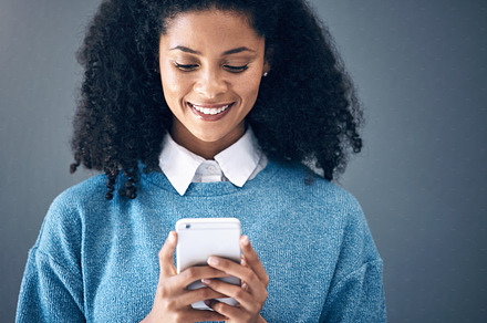 Phone, mockup and black woman in studio for internet, search or social media on grey background. Online, communication and girl texting on space, smartphone or copy space for website, app or reading, a Photo by Peopleimages.com