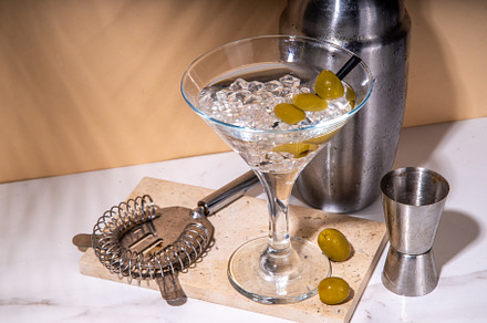 Classic martini cocktail with olive, a Food & Drink Photo by Rimma