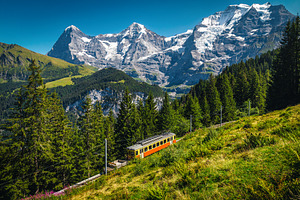 Electric train and Jungfrau mountain, a Nature Photo by Alpine Dreams