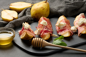 Sliced pear wrapped in prosciutto, topped with cream chees, a Food & Drink Photo by ndanko