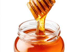 Honey jar with wooden dipper, a Food & Drink Photo by AlyaAnd