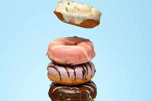 A stack of donuts with various fillings and glazes, several levi, a Food & Drink Photo by ndanko