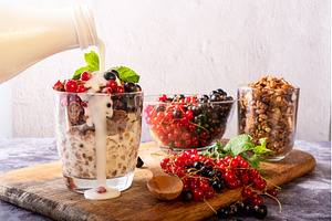Pouring milk into granola glass with, a Food & Drink Photo by Stockphoto by vzwer
