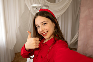 Teen girl smiling giving thumbs-up, a Person Photo by Elena Vagengeim