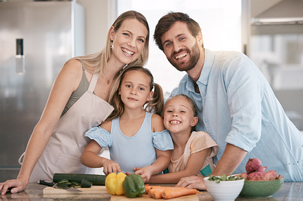 Kitchen, cooking and portrait of parents and children with vegetables for healthy diet, food or meal prep together. Family, smile and mom, dad and girls learning, teaching and helping cut ingredients, a Photo by Peopleimages.com