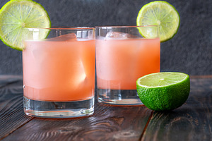 Two guava margaritas with lime wheel, a Food & Drink Photo by Alexander Prokopenko
