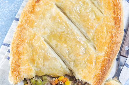 Individual beef pot pie or deep dish pie in baking dish, crust broken open, ver, a Food & Drink Photo by iuliia_n