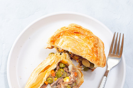Sliced beef pot pie on plate, vertical, top view, copy space, a Food & Drink Photo by iuliia_n