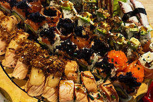 A diverse sushi platter on a wooden board in a restaurant ., a Photo by AS photostudio
