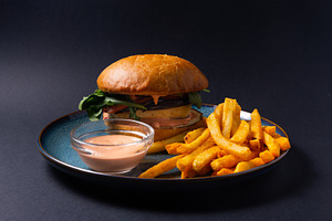 Classic burger with French fries and dipping sauce on a plate. D, a Food & Drink Photo by MDBildes