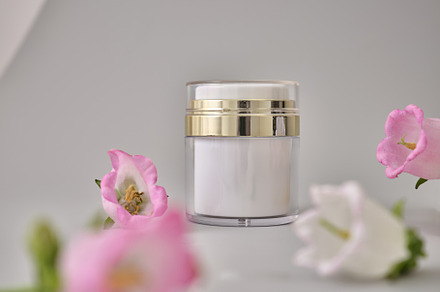 Skincare products on neutral background. Mockup bottles and flow