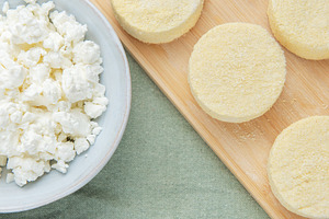 Syrniki preparation showcasing cottage cheese pancakes on cuttin, a Food & Drink Photo by Olena Rudo