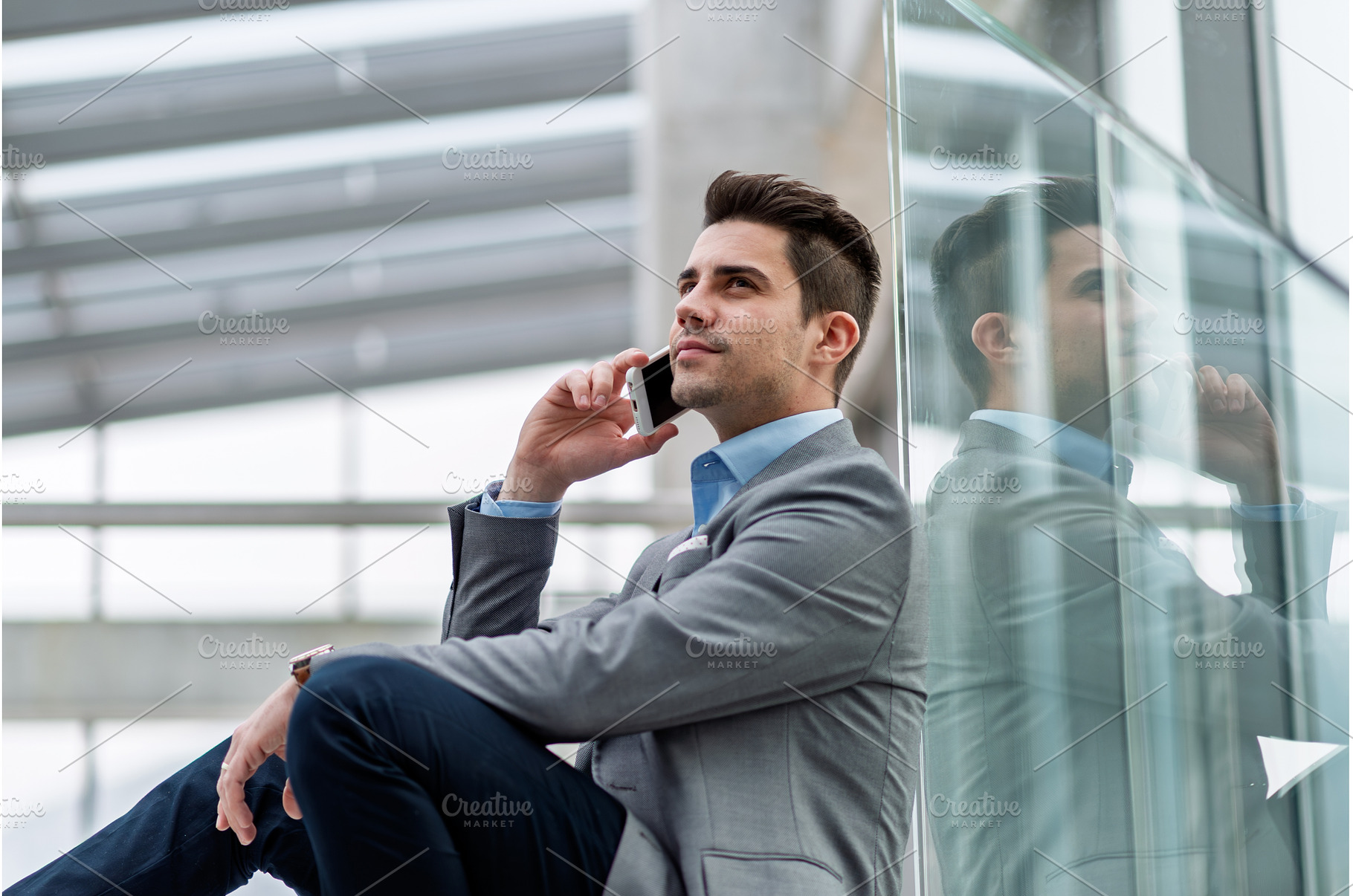 Young businessman making phone call, a Person Photo by HalfPoint