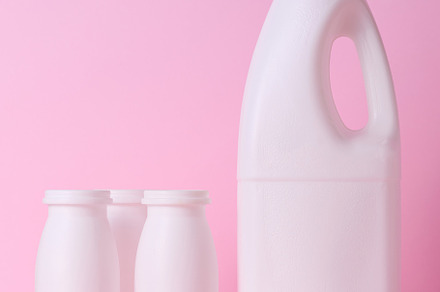 White plastic bottle for milk and dairy products on a pink backg, a Food & Drink Photo by ndanko