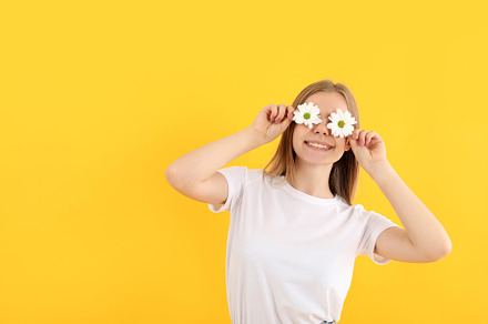 Attractive girl with flowers on yellow background, a Person Photo by AtlasStudio PRO