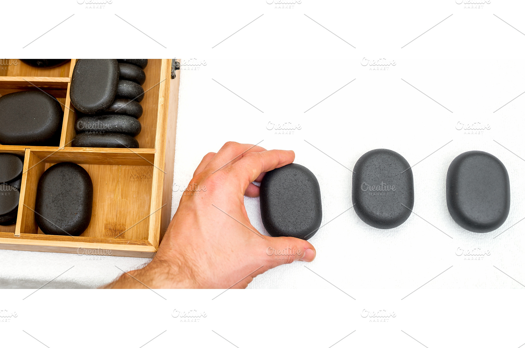 Hot stones for massage in a wooden, a Health & Medical Photo by okskukuruza