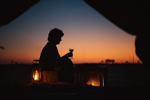 Enjoying sunset with drink in hand, a Photo by Beautiful things