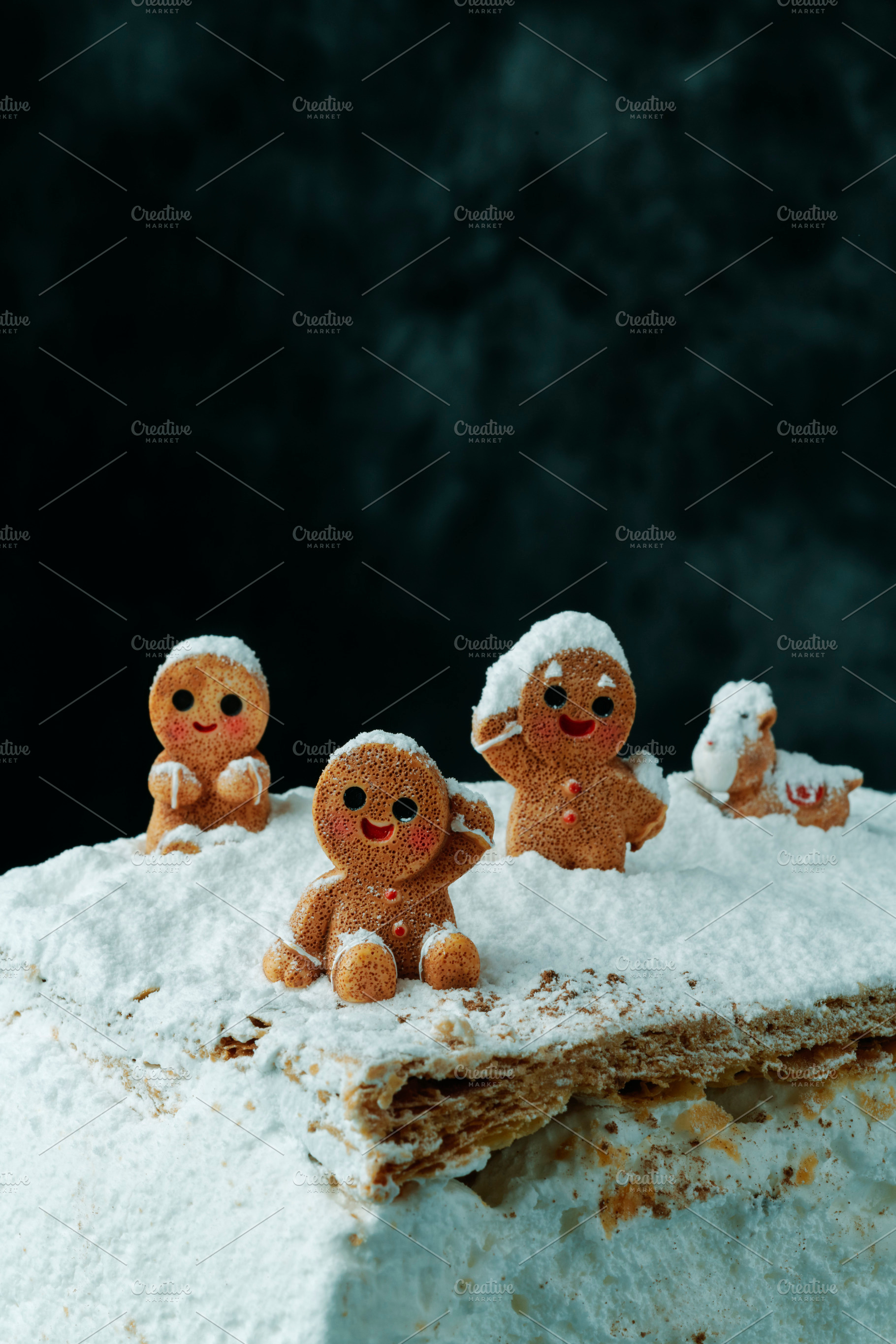 group of gingerbread men in snow, a Photo by Nito