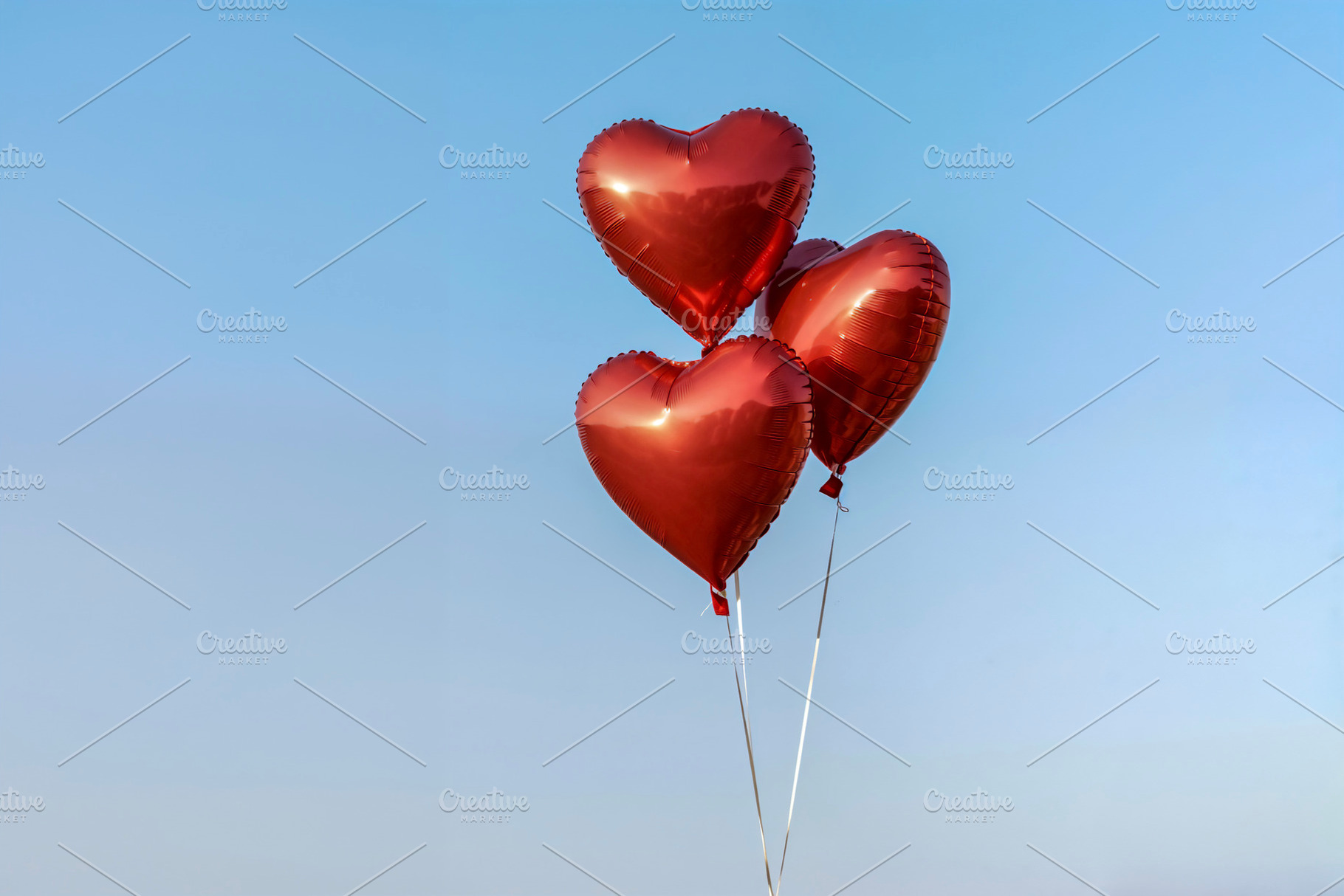 Three Red Heart Balloons Floating, a Photo by rarrarorro
