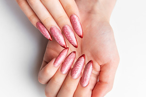 Woman's hands showing long pink glitter stiletto nails, a Beauty & Fashion Photo by Olena Rudo