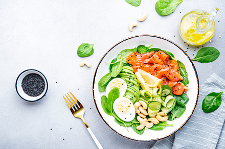Ketogenic salad with salted salmon, avocado, spinach, cucumber,, a Food & Drink Photo by 5PH