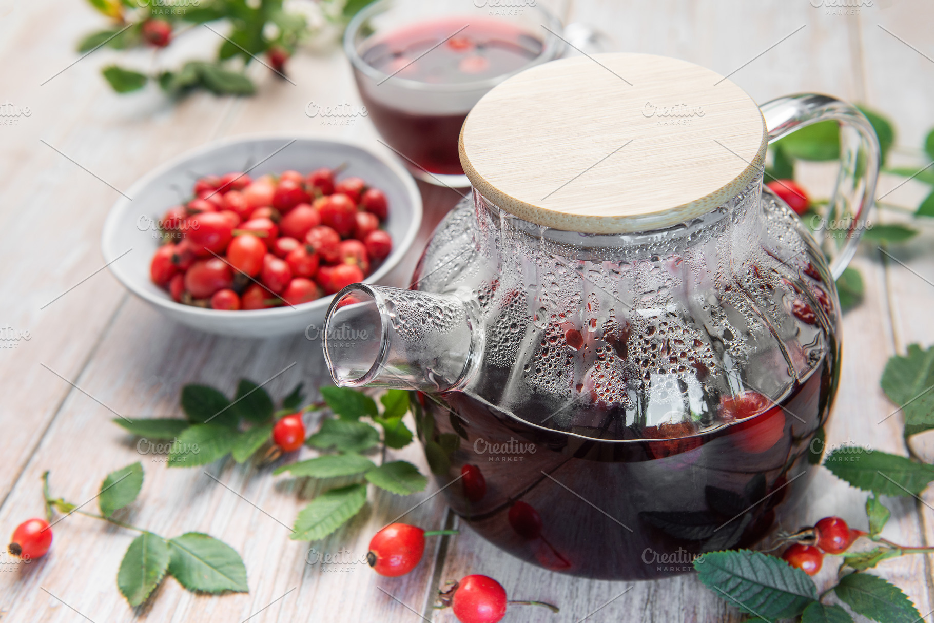 Steaming rosehip tea brewing in glass teapot with fresh rosehips, a Food & Drink Photo by Olena Rudo