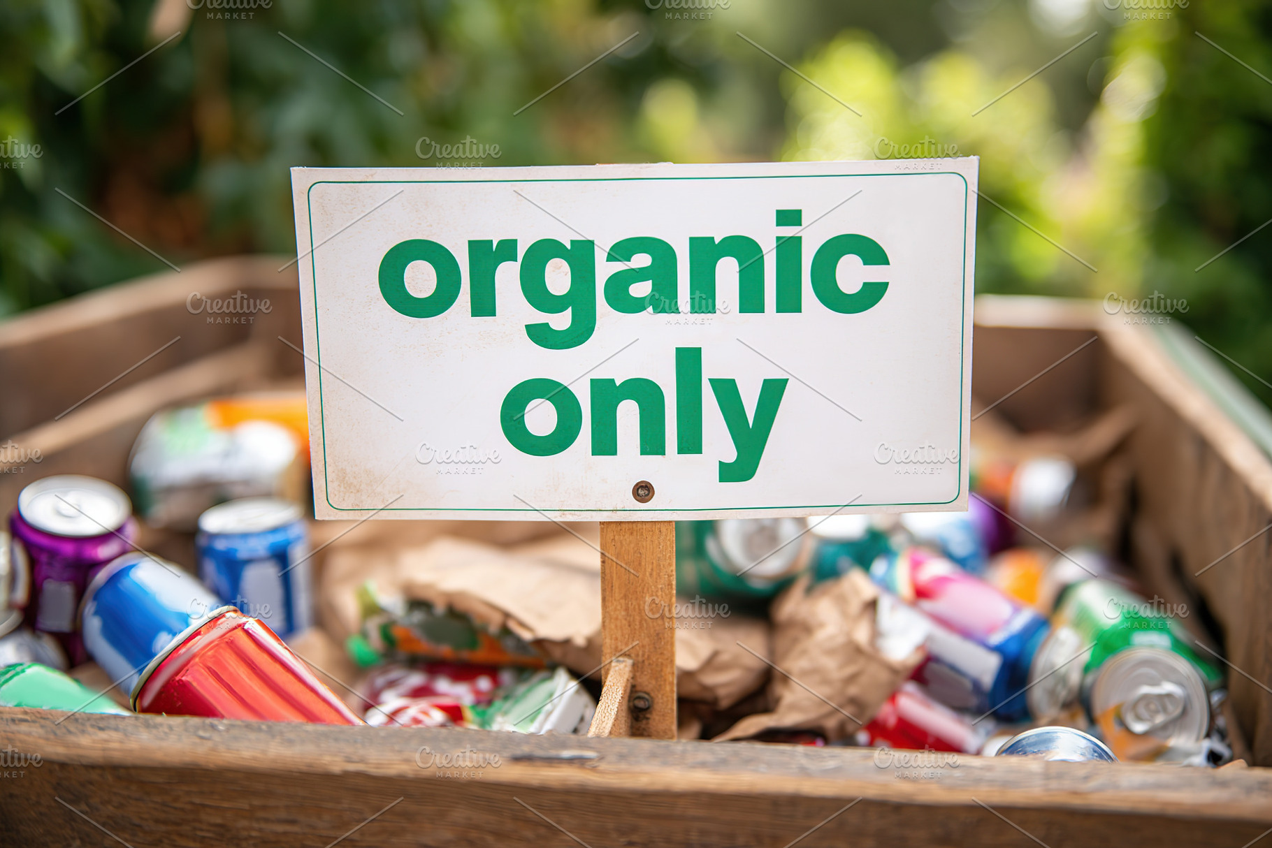 Bin marked organic only is filled with non-organic trash in a recycling area, a Photo by AlyaAnd