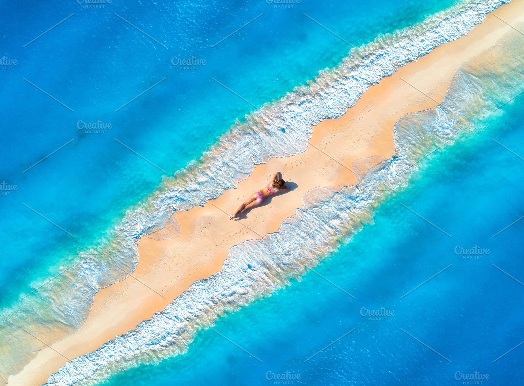Aerial view of the beautiful young lying woman on the sandy beac, a Holiday Photo by den-belitsky