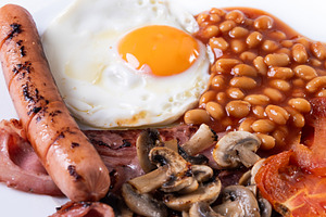 Full English breakfast with fried egg, bacon, sausages and beans, a Food & Drink Photo by etorres69