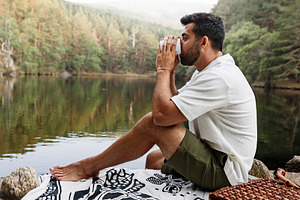 Man enjoying coffee in front of a la, a Person Photo by Perpis