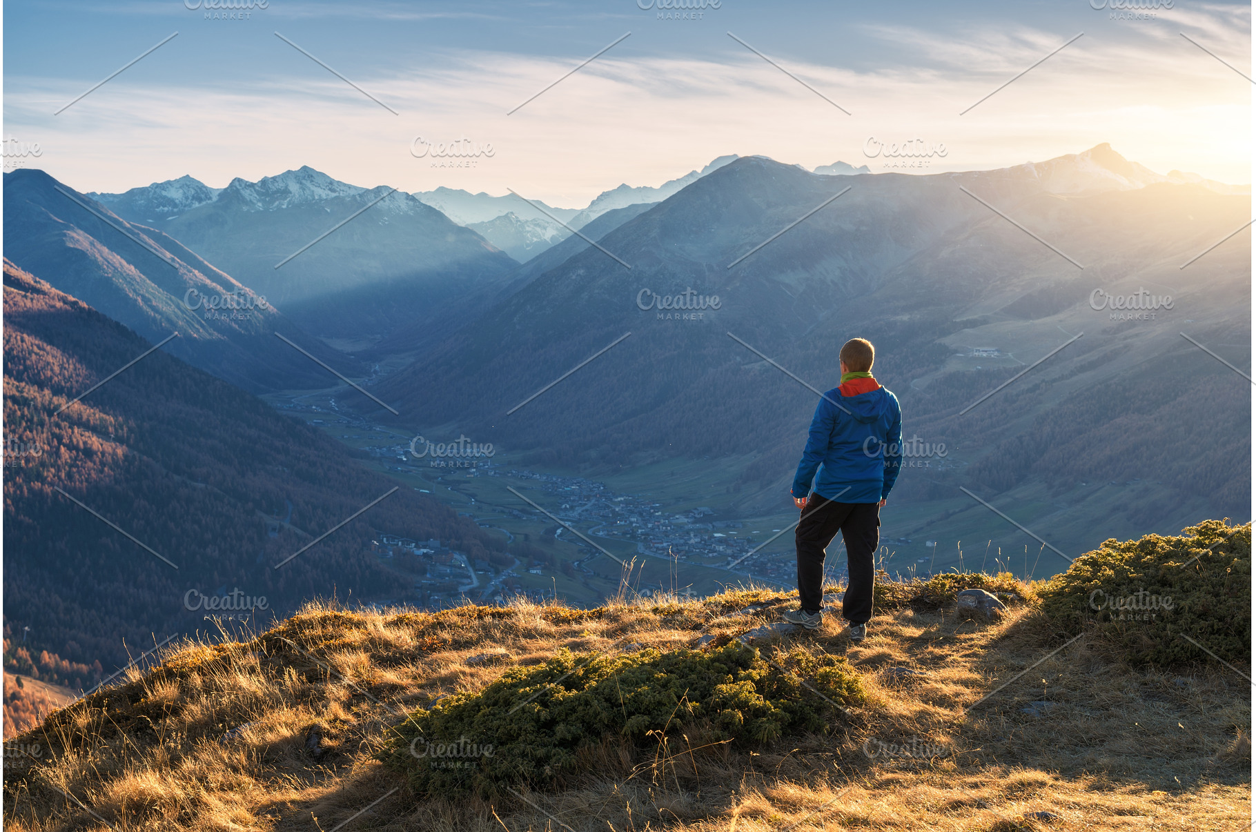 Young man standing on grassy, a Nature Photo by den-belitsky