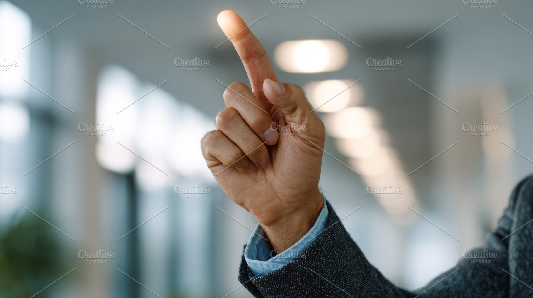 A close-up of a man's hand pointing upward, suggesting an idea or inspiration,, a Person Photo by ImageMir