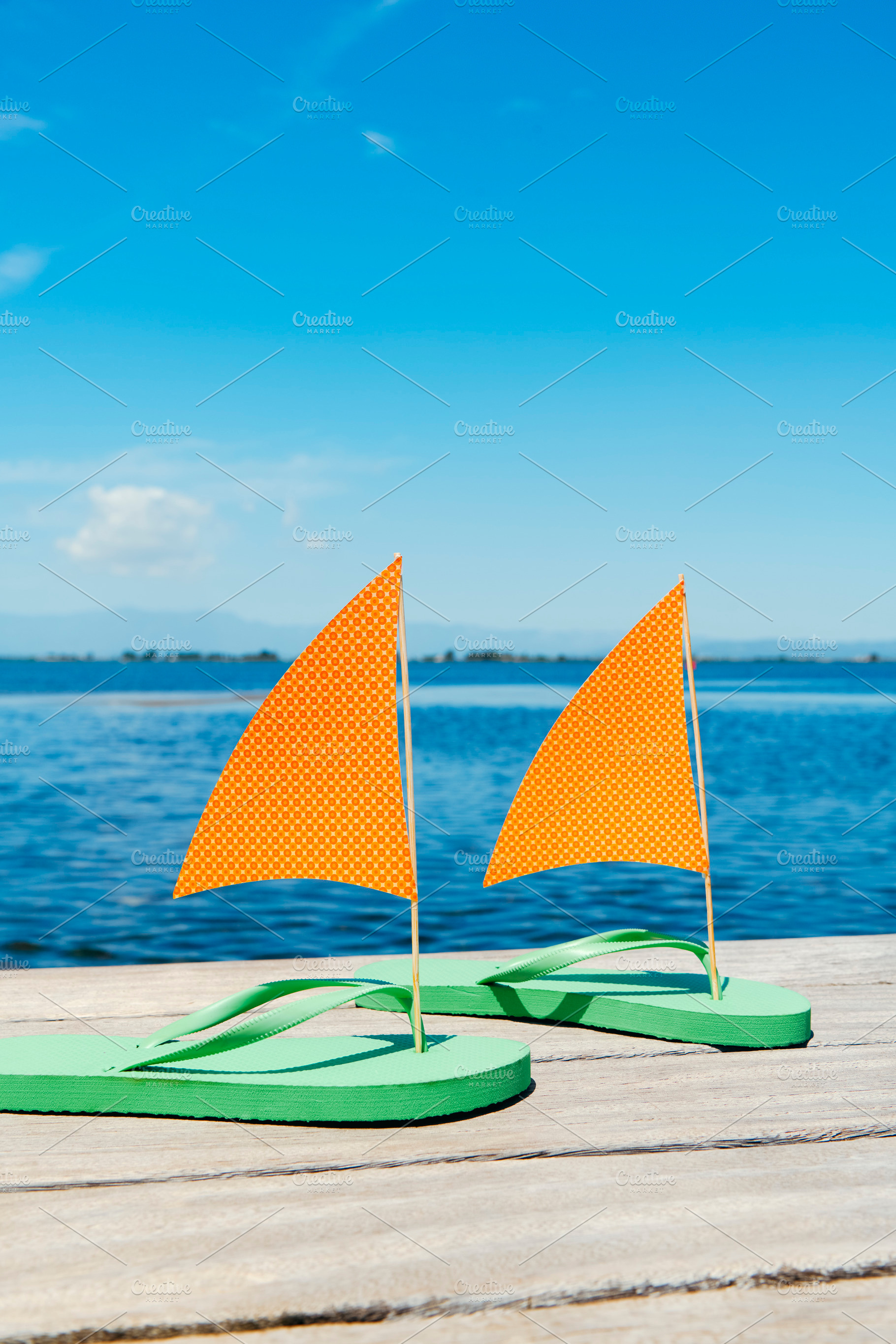 flip-flop sailboats beneath a wide blue sky, a Photo by Nito