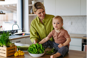 Mom and little boy preparing lettuce, a Food & Drink Photo by HalfPoint