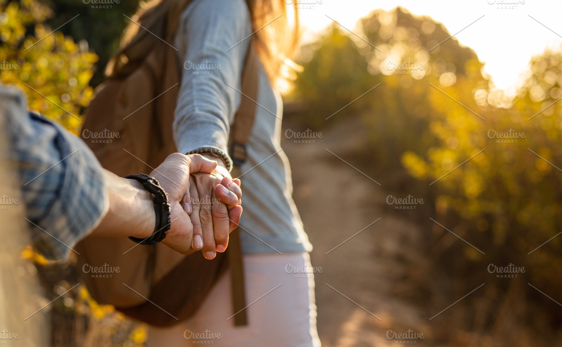 Hiking couple holding hands, a Person Photo by Jacob Lund