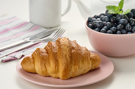 Baked crisp croissant on a wooden board, a plate with blueberry,, a Food & Drink Photo by ndanko
