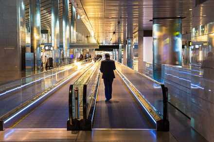Interior of airport with moving walkway in Doha, a Transportation Photo by Vapi