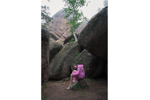 Woman in the taiga forest and rocks, a Person Photo by Jan Jack Russo Media