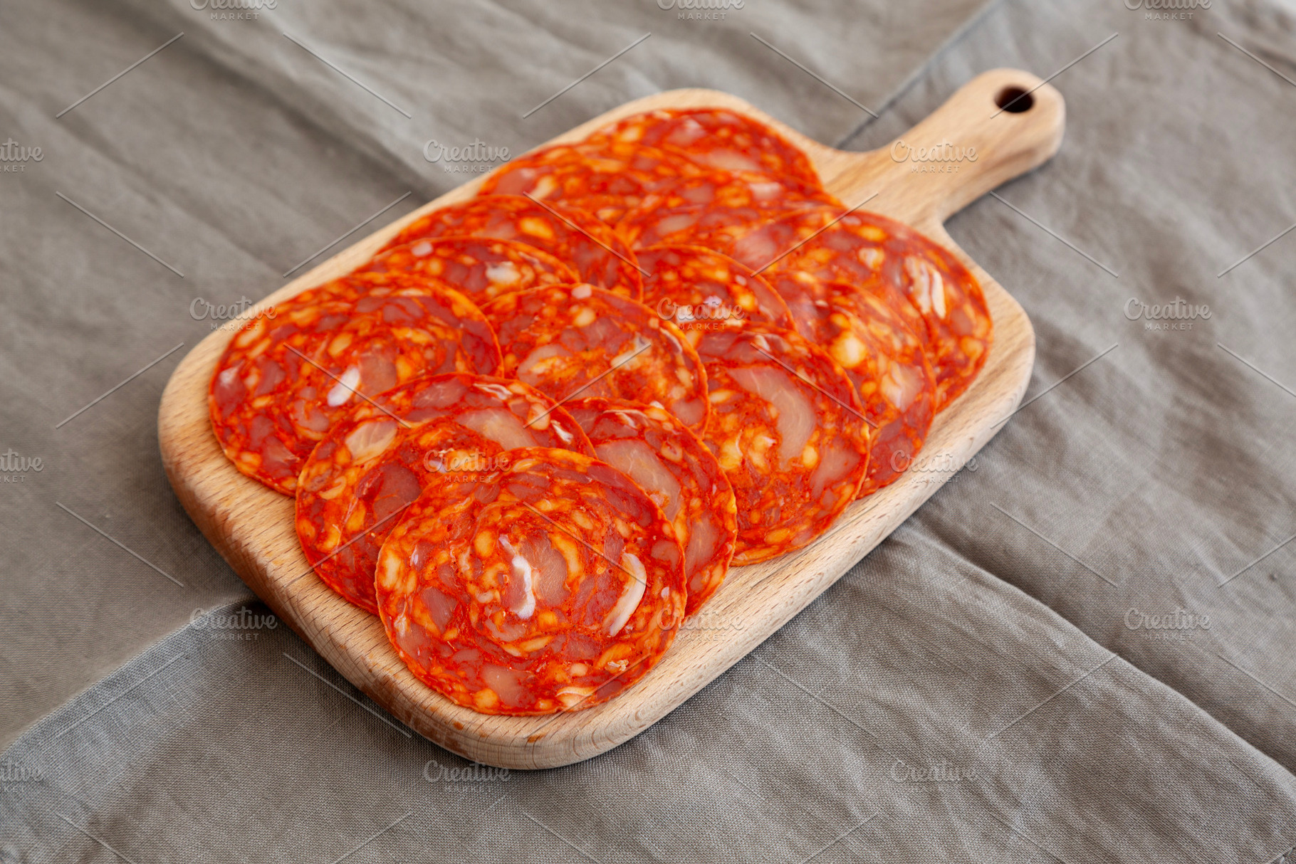 Cold Meat Chorizo Slices on a Wooden Board, side view., a Food & Drink Photo by LiudmylaChuhunova