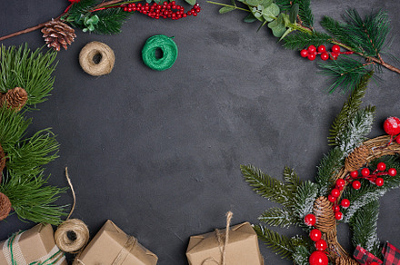 Christmas wreaths, fir branches and gifts on a black background., a Holiday Photo by ndanko
